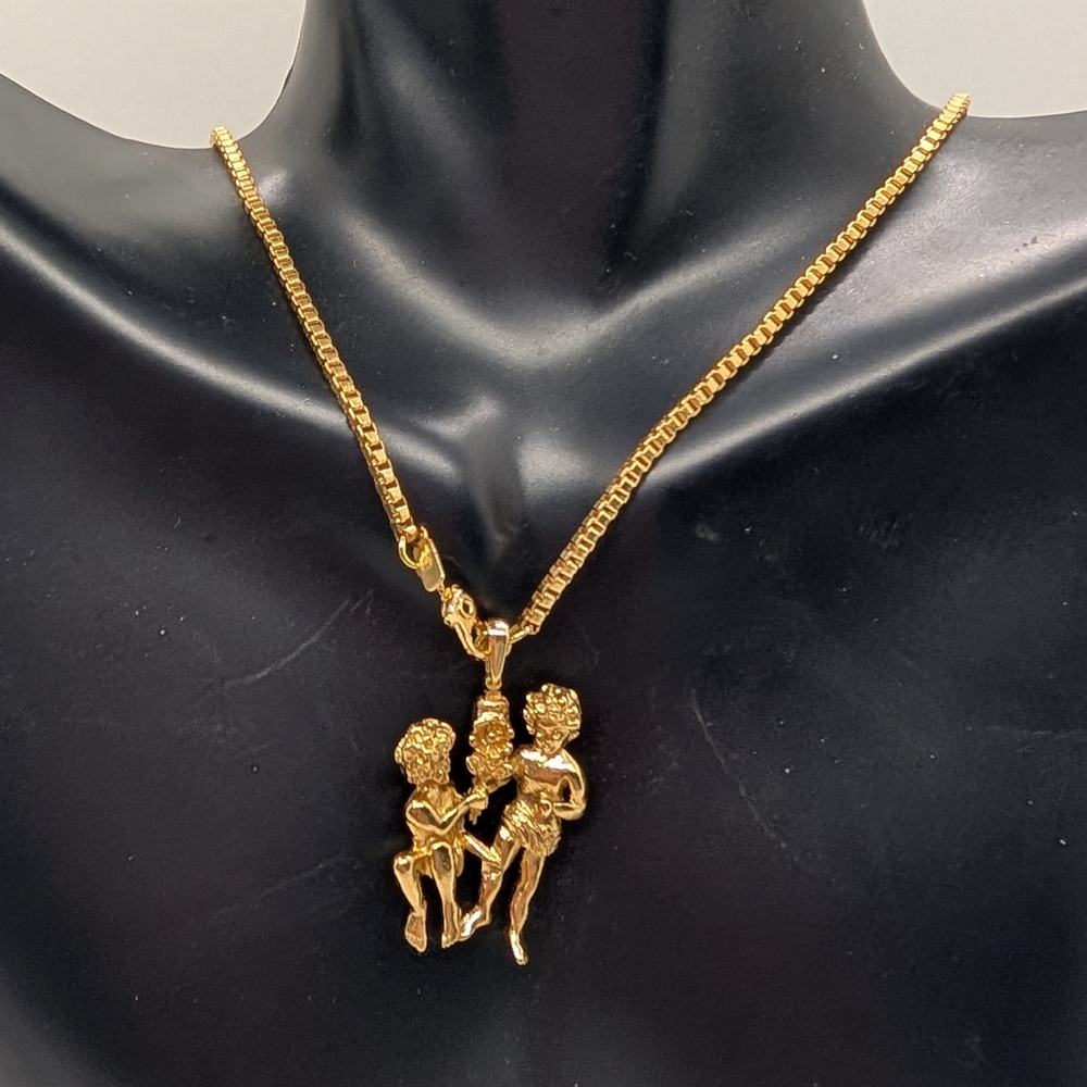 Monet Twin Cherubs with a Flower Gold Tone Vintage Necklace